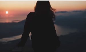 晚霞中吹着微风的女子人物视频素材